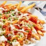 Homemade buffalo fries on platter and a kitchen towel next to it.