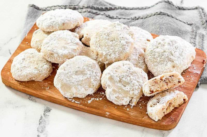 Copycat David's cookies butter pecan meltaways on a platter on a marble surface.