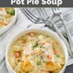Creamy chicken pot pie soup with potatoes, carrots, peas, and puff pastry.