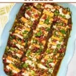 An appetizer of cheddar and cream cheese slices marinated with sundried tomato herb oil.