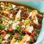 Sliced cream cheese and cheddar cheese in sundried tomato marinade.