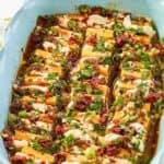 Sundried tomato, garlic, and herb marinated sliced cheeses in a serving dish.