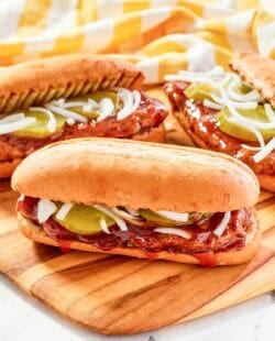 Copycat McDonald's McRib sandwiches on a wood platter.