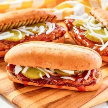 Copycat McDonald's McRib sandwiches on a wood platter.