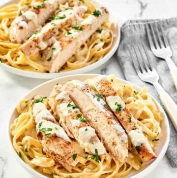 Two servings of copycat Olive Garden grilled chicken alfredo.