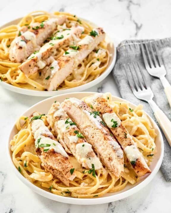 Two servings of copycat Olive Garden grilled chicken alfredo.