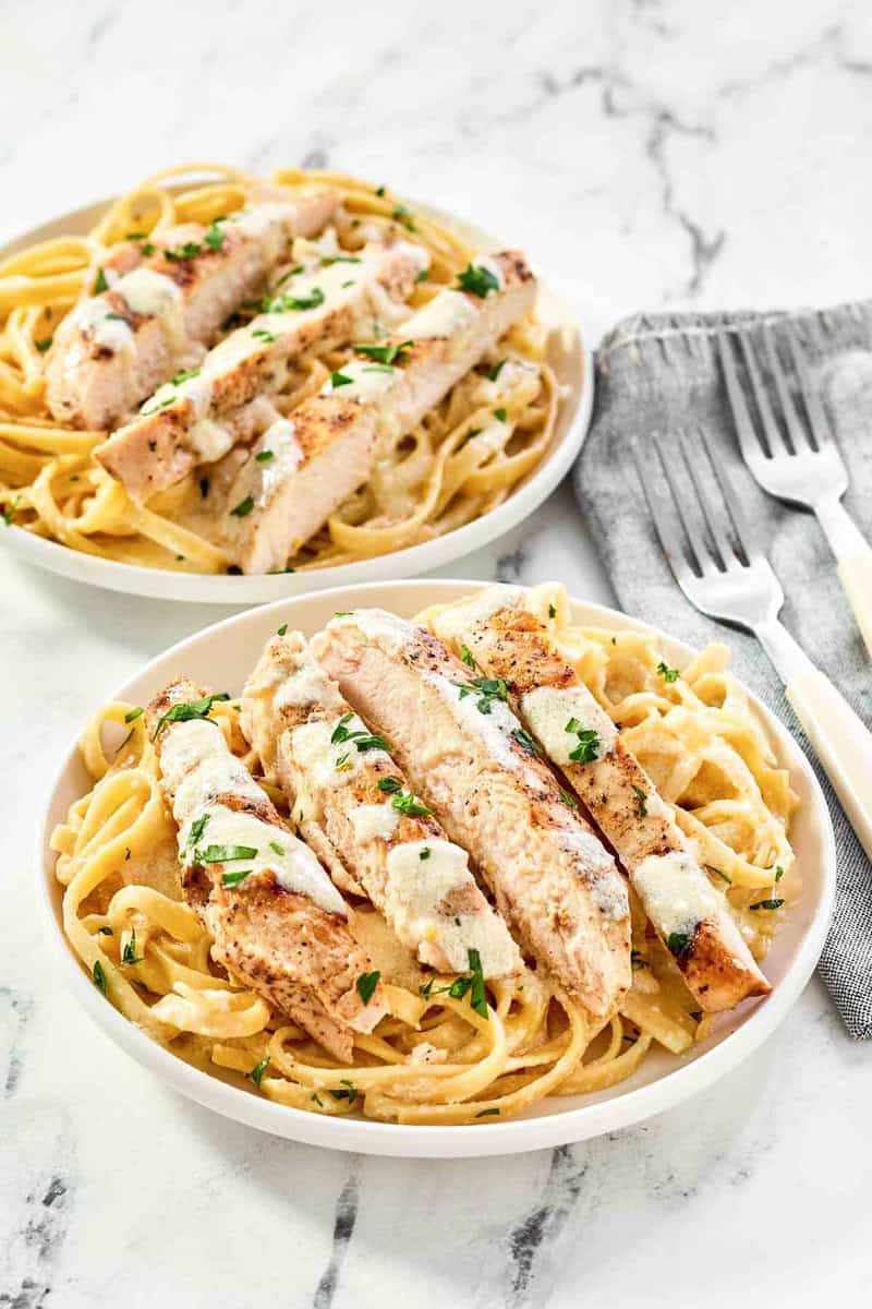 Two servings of copycat Olive Garden grilled chicken alfredo.