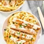 Two plates of homemade Olive Garden chicken alfredo.