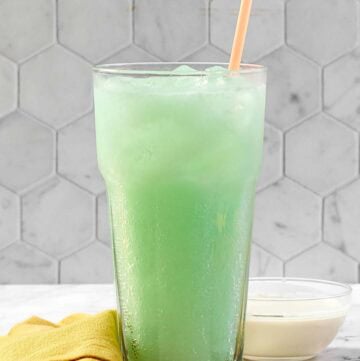 A glass of copycat Taco Bell Dirty Mountain Dew Baja Blast dream soda.