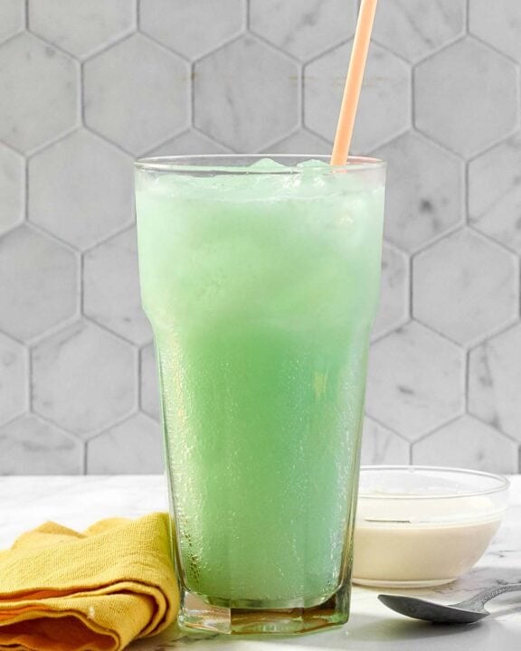 A glass of copycat Taco Bell Dirty Mountain Dew Baja Blast dream soda.