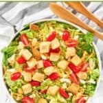 Homemade Texas Roadhouse house salad and salad tongs next to it.