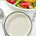 Homemade Texas Roadhouse ranch dressing in a jar on a marble surface.