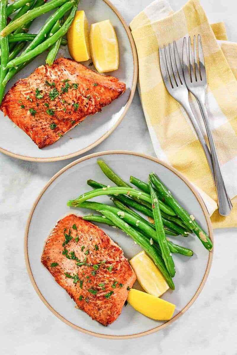 Flaky salmon cooked in lemon butter and served with green beans.