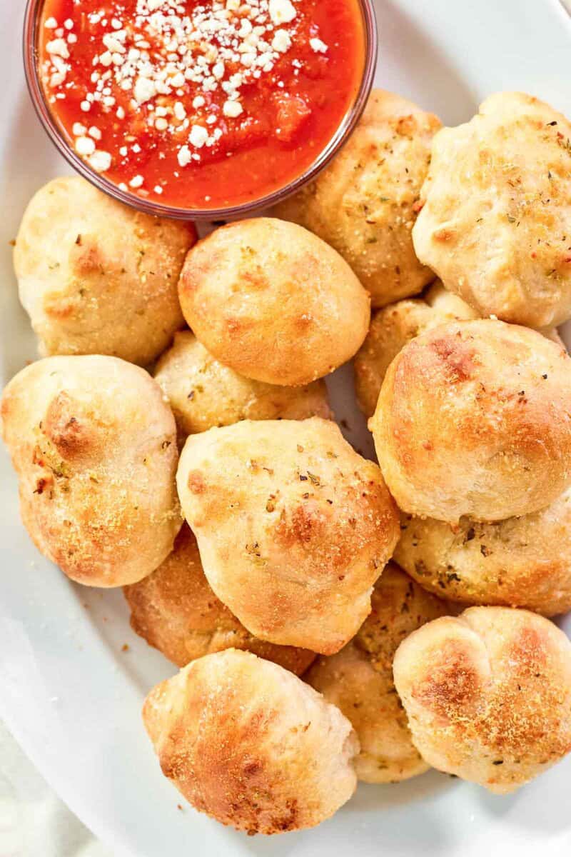 Cheesy bread bites with parmesan served with marinara for dipping.