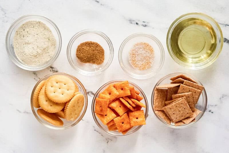 Dry ranch dressing mix, oil, Ritz Crackers, Cheeze-It crackers, Wheat Thins, and seasonsings.