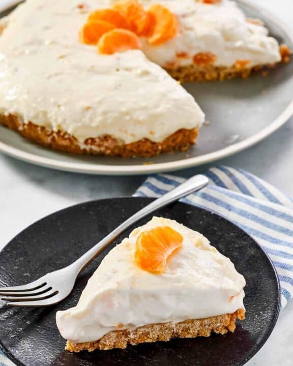 Creamy cheesecake made with mandarin oranges and topped with orange slices.