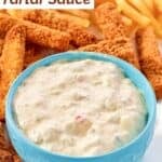 A bowl of freshly prepared tartar sauce served with fish sticks and fries.