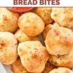 Closeup of round bread bites piled on a plate.