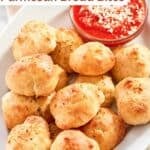 Fluffy bread balls and marinara dipping sauce on a platter.