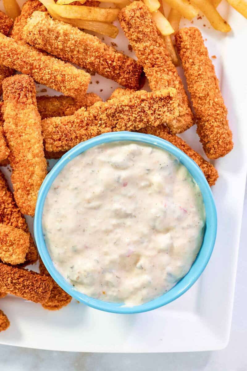 Creamy homemade tartar sauce served with crispy fish sticks.