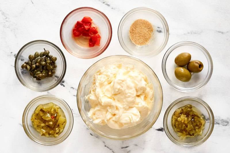 Mayonnaise, relish, capers, olives, peppers, and seasoning.