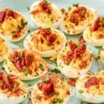 Creamy deviled eggs topped with brown sugar candied bacon bits.