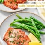 Lemon butter salmon fillet and green beans on a plate.