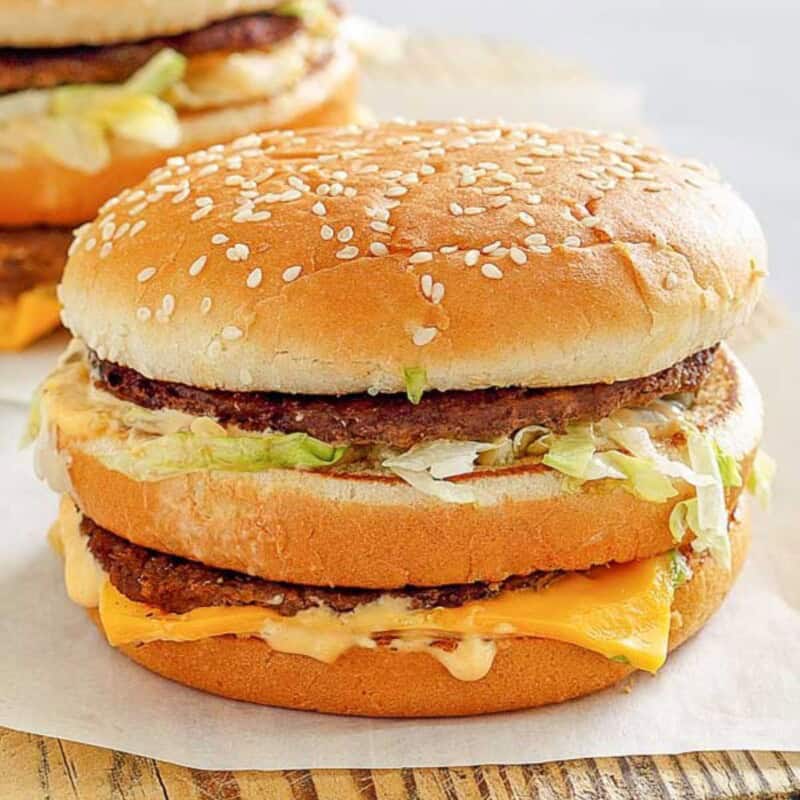 Cheeseburger with lettuce, cheese, and sesame bun.