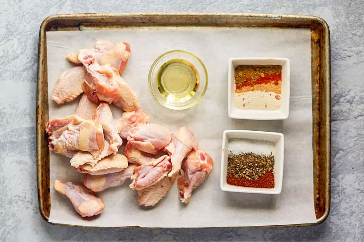 Raw chicken wings, oil, and spices.