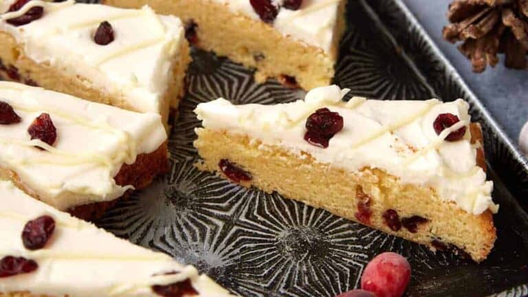 a frosted cranberry bar on a plate