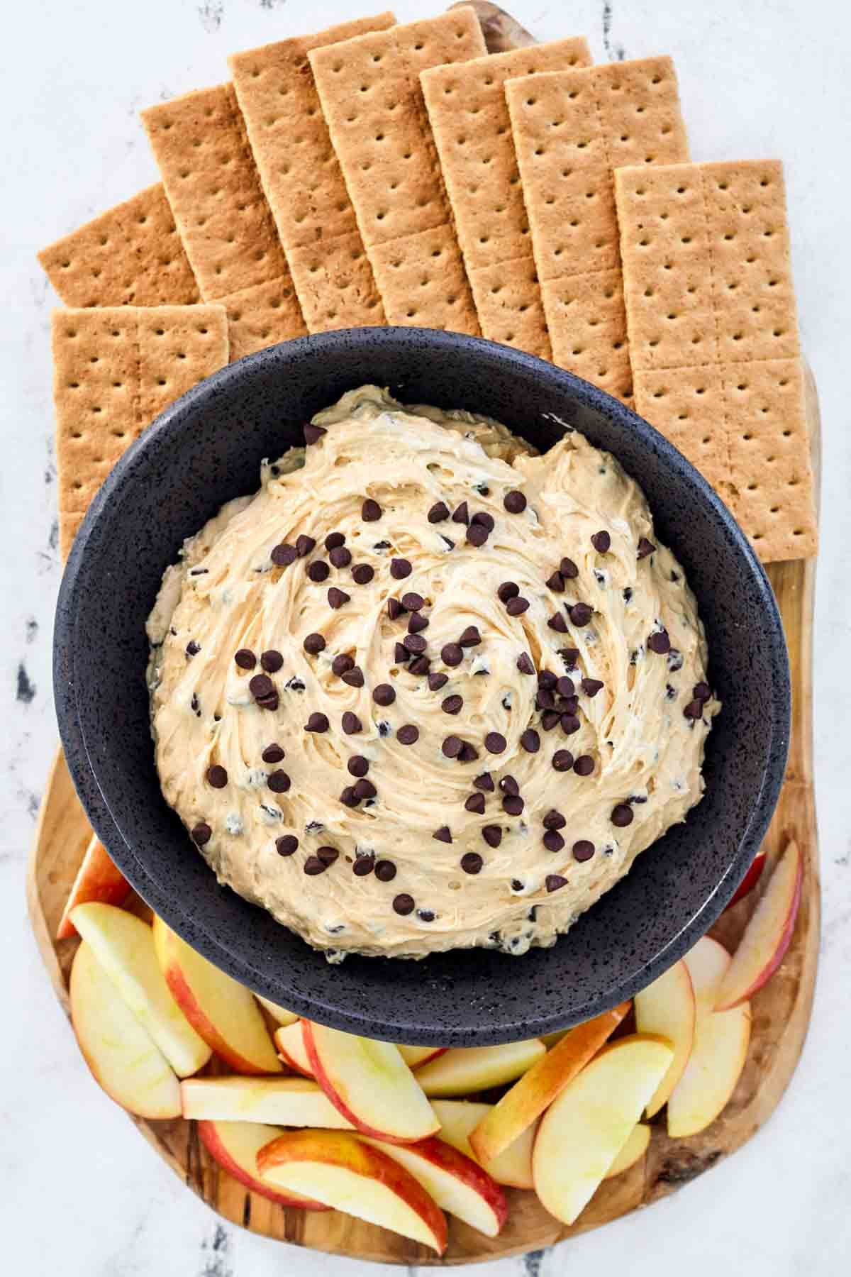 Cream cheese peanut butter dip with chocolate chips served with graham crackers and apple slices.