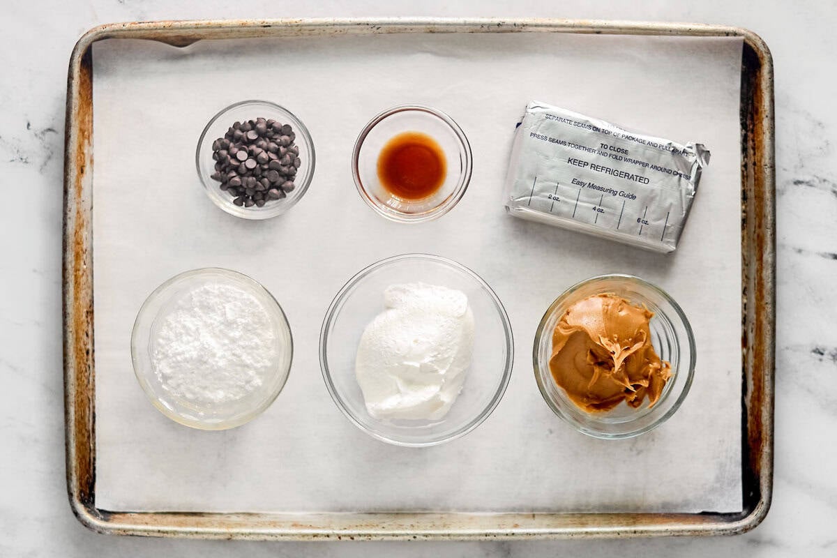 Cream cheese, powered sugar, peanut butter, chocolate chips, cool whip, and vanilla.