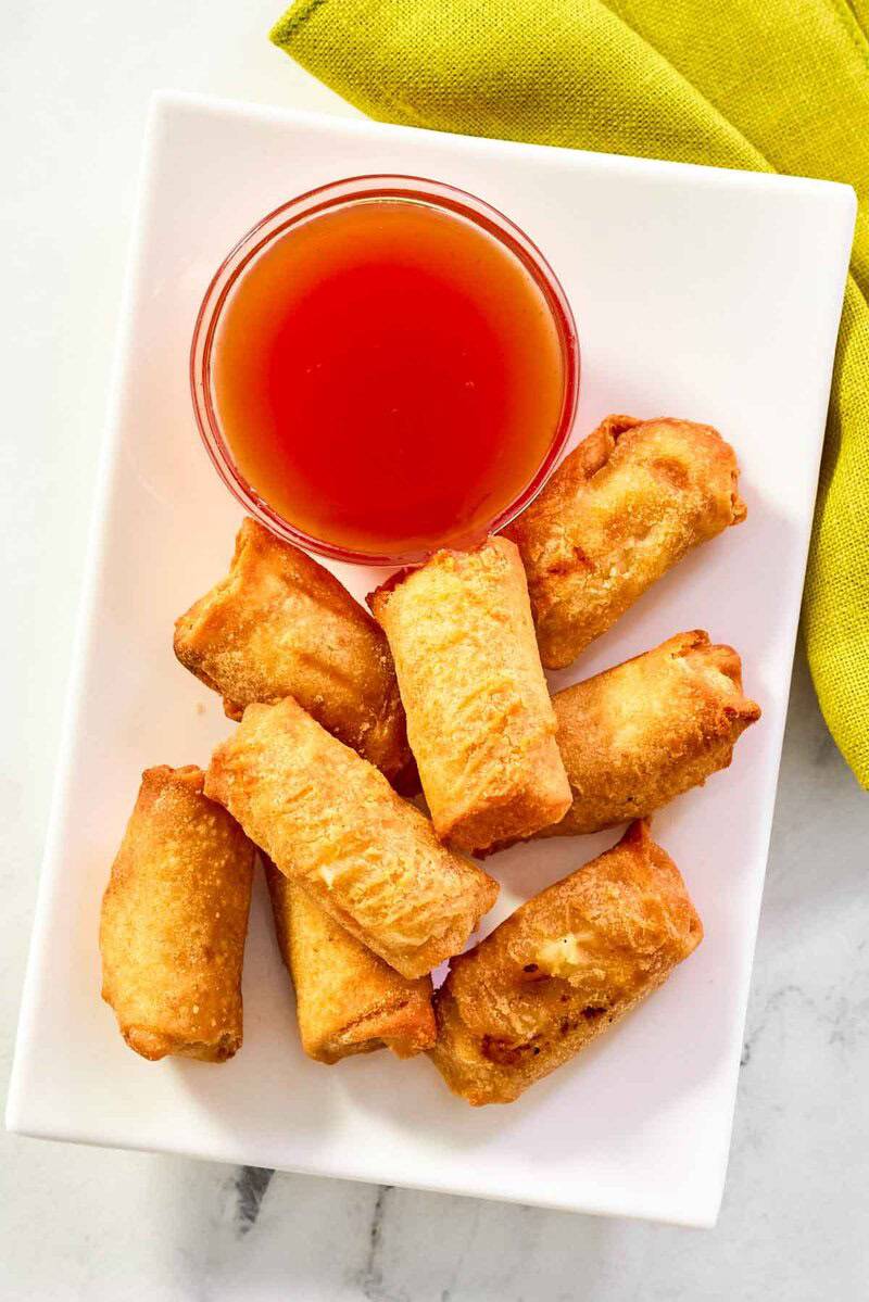Red Chinese sauce served with egg rolls.