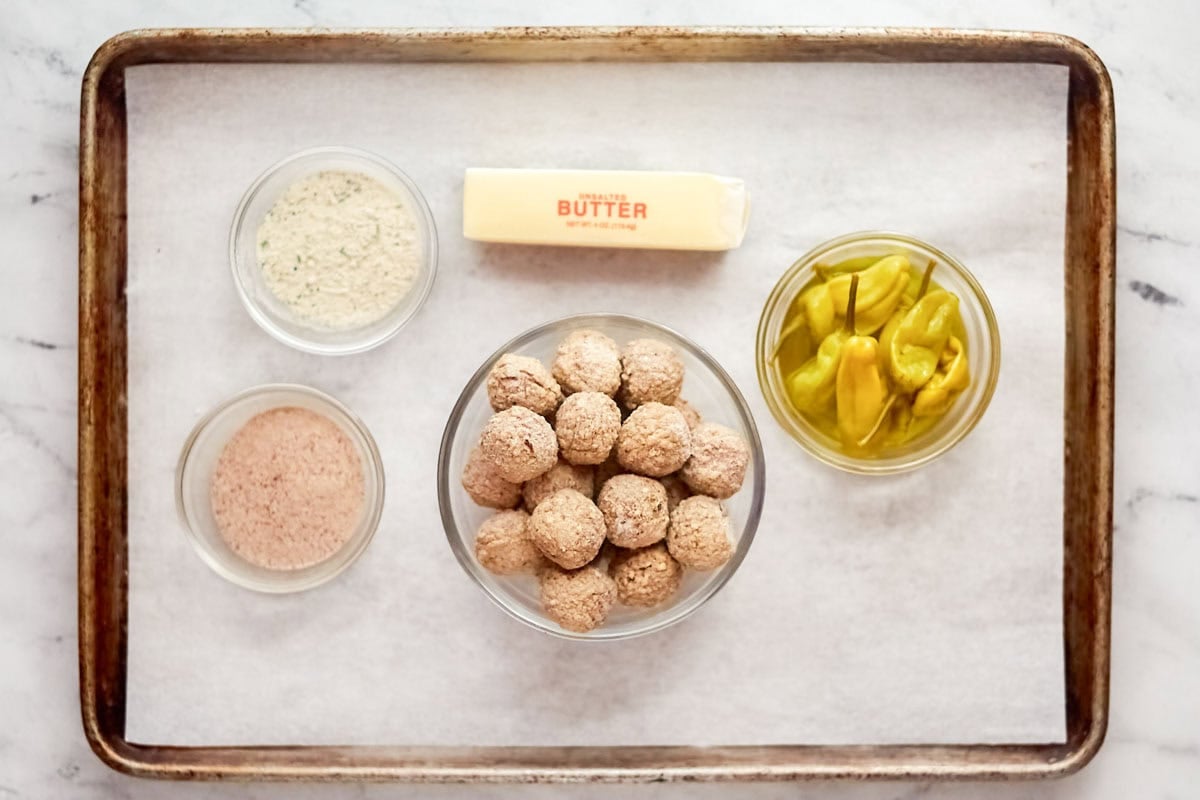 Frozen meatballs, pepperoncini, gravy mix, ranch dressing mix, butter, and pepperoncini.