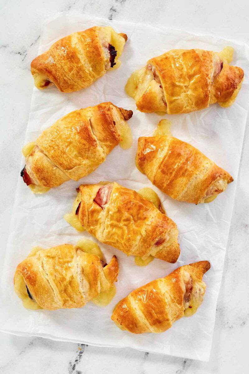 Freshly baked ham and cheese croissants made with crescent roll dough.