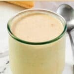 Spicy hot ranch sauce in a jar and a spoon beside it.