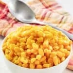 Cooked and buttered sweet corn kernels in a small bowl.