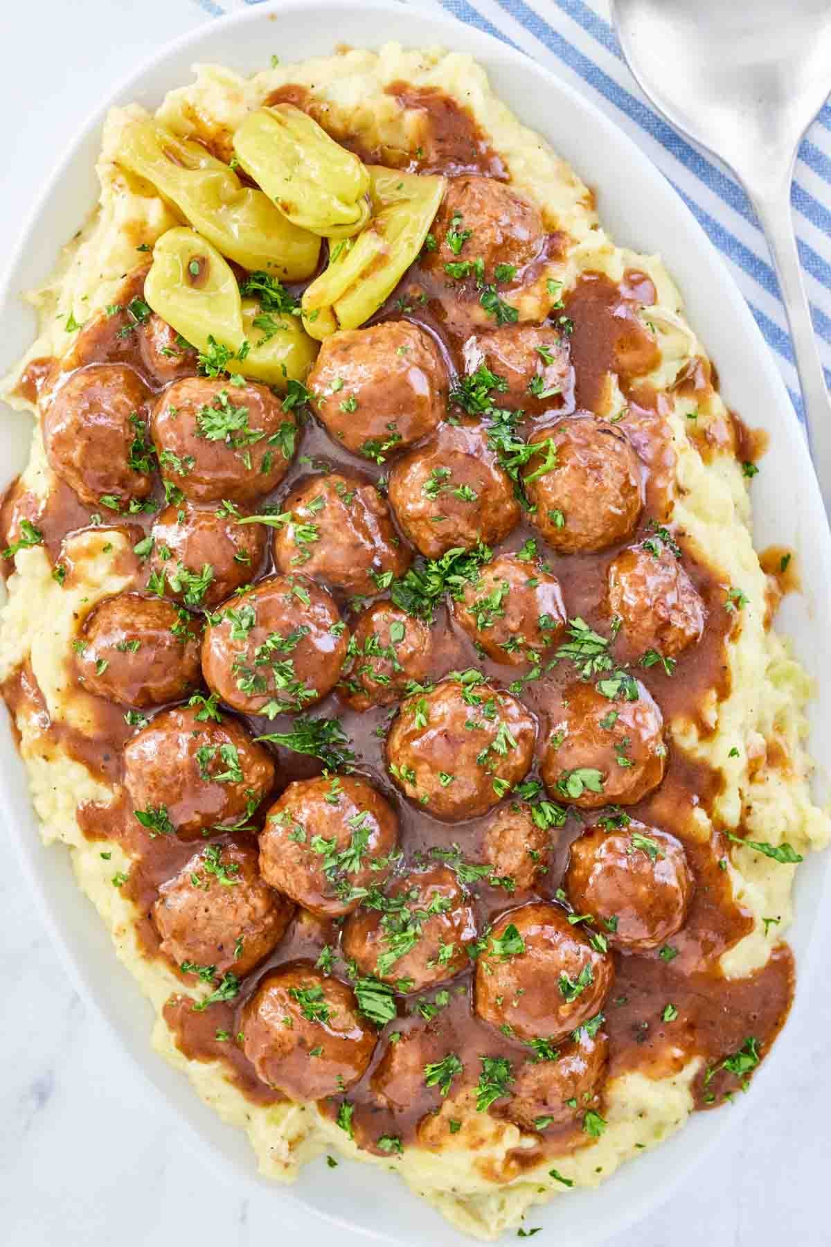 Homemade meatballs with pepperoncini sauce served over mashed potatoes.
