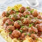 A platter of homemade Mississippi meatballs and gravy served over mashed potatoes.