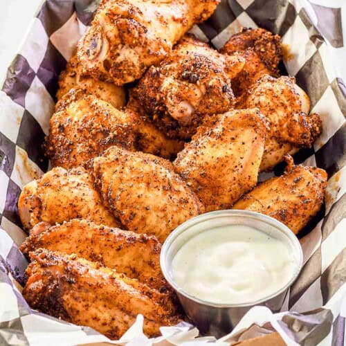Seasoned and smoked chicken wings served with dipping sauce.