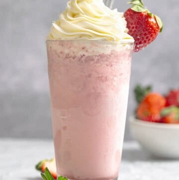 A strawberry cream frappe with whipped cream topping.