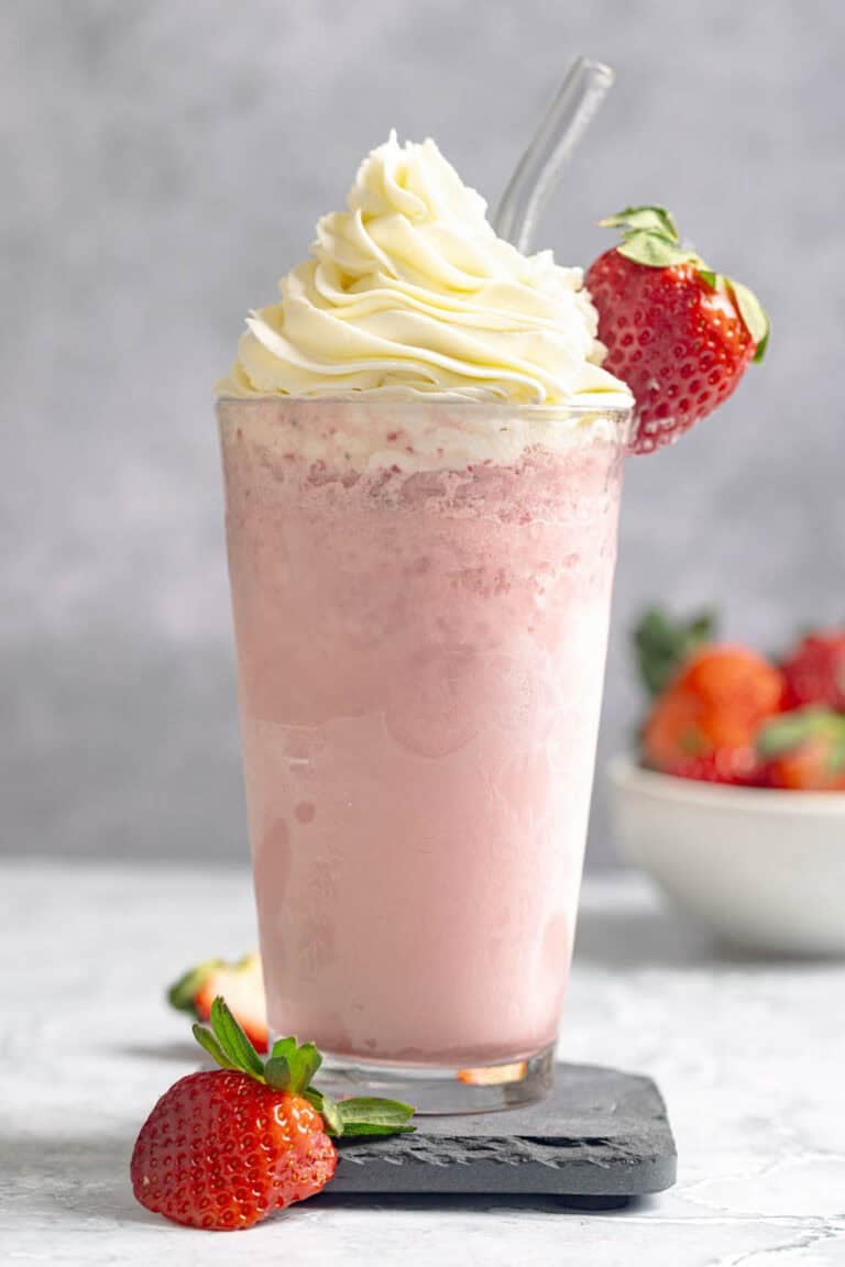 A strawberry cream frappe with whipped cream topping.