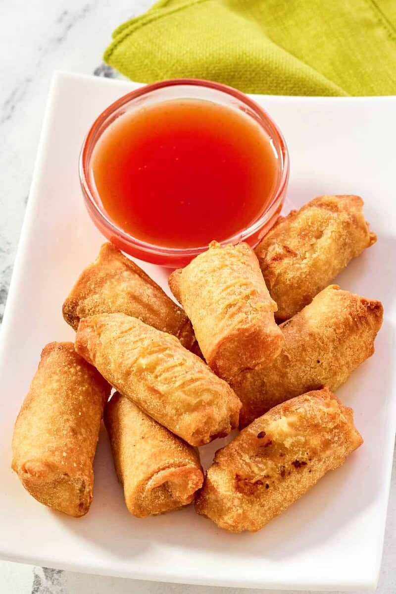Homemade red sweet and sour sauce served with egg rolls.