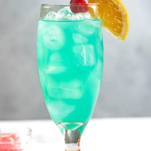 A blue curacao coconut rum cocktail served in a tall glass.