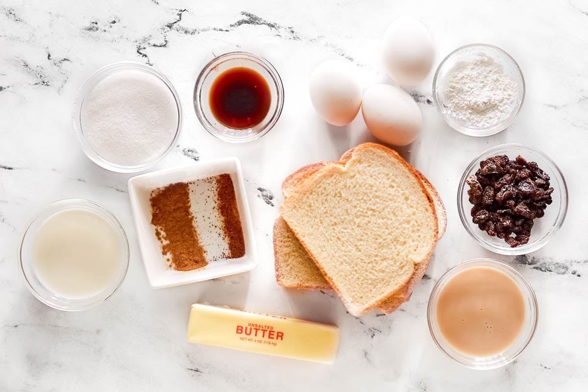 Bread slices, eggs, butter, sugar, flour, raisins, and seasonings.