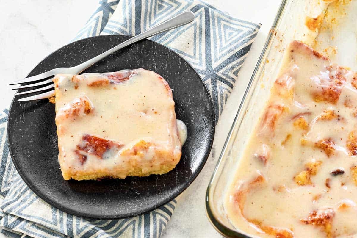 Bread pudding covered in creamy sauce.