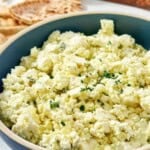 Homemade Cava crazy feta and pita bread triangles behind it.