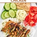 Copycat Cava harissa honey chicken served with rice, feta spread, pita bread, and veggies.