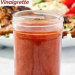 A jar of homemade CAVA hot harissa vinaigrette.