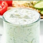 Homemade CAVA tzatziki sauce in a small glass jar.